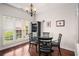 Dining area featuring hardwood floors, modern lighting, and a view of the landscaped backyard at 7994 Larksview Dr, Fairburn, GA 30213