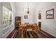 Formal dining room with wainscoting, a large window, and a stylish chandelier at 7994 Larksview Dr, Fairburn, GA 30213