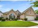 Charming brick home with manicured lawn, complemented by mature shrubs and an attached two-car garage at 7994 Larksview Dr, Fairburn, GA 30213