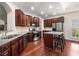 Modern kitchen featuring stainless steel appliances, dark wood cabinets, and a kitchen island with seating at 7994 Larksview Dr, Fairburn, GA 30213