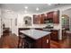 Open concept kitchen featuring dark wood cabinets, stainless appliances, and center island at 7994 Larksview Dr, Fairburn, GA 30213