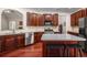 Modern kitchen featuring stainless steel appliances, custom cabinets, an island, and hardwood floors at 7994 Larksview Dr, Fairburn, GA 30213