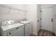 Functional laundry room with washer, dryer, shelving, and access to the garage at 7994 Larksview Dr, Fairburn, GA 30213