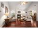 Spacious living room with hardwood floors, a fireplace, and plenty of natural light at 7994 Larksview Dr, Fairburn, GA 30213