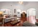 Inviting living room featuring arched doorways, hardwood floors, and neutral decor at 7994 Larksview Dr, Fairburn, GA 30213