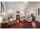 Bright living room with fireplace, archways, hardwood floors, and a vaulted ceiling at 7994 Larksview Dr, Fairburn, GA 30213