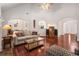 Bright living room with high ceilings, arched doorways, hardwood floors, and a comfortable seating area at 7994 Larksview Dr, Fairburn, GA 30213