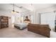 Bright and airy main bedroom with a tray ceiling, sitting area, and neutral tones at 7994 Larksview Dr, Fairburn, GA 30213