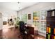 Bright office with hardwood flooring, ample natural light, and built-in bookcase for storage at 7994 Larksview Dr, Fairburn, GA 30213