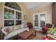 Cozy screened-in patio with comfortable seating and ample natural light at 7994 Larksview Dr, Fairburn, GA 30213