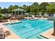 Large community swimming pool with slide, seating and lake views at 7994 Larksview Dr, Fairburn, GA 30213
