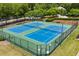 Aerial of two blue community tennis courts surrounded by fencing at 7994 Larksview Dr, Fairburn, GA 30213