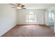 Spacious bedroom features neutral walls, carpet flooring, a window and entry to a bathroom at 900 Mill Stone Dr, Marietta, GA 30062