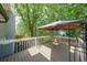 A deck with a canopy, wooden railing, and an air conditioning unit at 900 Mill Stone Dr, Marietta, GA 30062