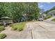 A long driveway and a view of the house, deck, lake, and lawn at 900 Mill Stone Dr, Marietta, GA 30062