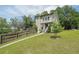 Two-story home with a lush green lawn and landscaping, fenced yard, and mature shade trees at 900 Mill Stone Dr, Marietta, GA 30062