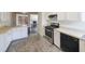 Modern kitchen featuring white cabinets, stainless steel appliances, and an eat-in countertop at 900 Mill Stone Dr, Marietta, GA 30062