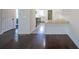 Bright living room featuring beautiful wood floors, white walls, and seamless kitchen access at 900 Mill Stone Dr, Marietta, GA 30062