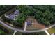 Aerial view of a 2 acre property with a charming blue two-story home in a wooded location at 1056 Riverstone Dr, Social Circle, GA 30025