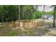Wood-fenced area near the main house with lush greenery, surrounded by natural trees at 1056 Riverstone Dr, Social Circle, GA 30025