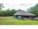 Open backyard area with lush lawn and perimeter fencing, backing onto a wooded area at 1056 Riverstone Dr, Social Circle, GA 30025