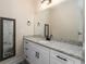 Bathroom with white cabinets, granite countertops, large mirror, and unique framed mirror on the side at 1056 Riverstone Dr, Social Circle, GA 30025