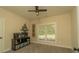 Bedroom featuring neutral paint, ceiling fan, shelving and natural light through the window at 1056 Riverstone Dr, Social Circle, GA 30025