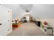 Attic bedroom features carpet flooring, angled ceiling, storage, and furniture at 1056 Riverstone Dr, Social Circle, GA 30025