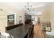 Open dining space with modern chandelier, dining table, and kitchen view at 1056 Riverstone Dr, Social Circle, GA 30025