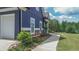 Exterior side elevation featuring a driveway and landscaped pathway leading to the front of the house at 1056 Riverstone Dr, Social Circle, GA 30025
