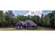Charming blue two-story home with a landscaped yard and inviting front porch at 1056 Riverstone Dr, Social Circle, GA 30025