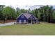 Charming blue two-story home with a landscaped yard and inviting front porch at 1056 Riverstone Dr, Social Circle, GA 30025