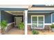 Inviting front porch featuring stone accents, ample seating, and a beautifully decorated entranceway at 1056 Riverstone Dr, Social Circle, GA 30025
