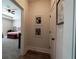Hallway leads to carpeted bedroom; features Gathering photos and wood flooring at 1056 Riverstone Dr, Social Circle, GA 30025