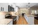 Gourmet kitchen with stainless steel appliances, gas range, and a center island overlooking the dining area at 1056 Riverstone Dr, Social Circle, GA 30025