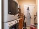 Laundry room with front load washer and dryer, wooden cabinets, and storage space at 1056 Riverstone Dr, Social Circle, GA 30025