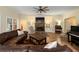 Inviting living room featuring a stone fireplace, plush seating, and warm lighting for a cozy ambiance at 1056 Riverstone Dr, Social Circle, GA 30025