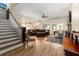 Open-concept living room with hardwood floors, neutral colors, and comfortable seating at 1056 Riverstone Dr, Social Circle, GA 30025