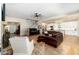 Open concept living room featuring hardwood floors, a fireplace, and a view of the modern kitchen at 1056 Riverstone Dr, Social Circle, GA 30025