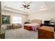 Spacious main bedroom featuring a tray ceiling, sitting area, and ample natural light at 1056 Riverstone Dr, Social Circle, GA 30025