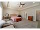 Large main bedroom with a seating area, walk-in closet, and neutral decor at 1056 Riverstone Dr, Social Circle, GA 30025