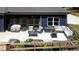 Outdoor patio with wicker furniture, grill, and outdoor dining; garden in the foreground at 1056 Riverstone Dr, Social Circle, GA 30025