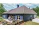 Outdoor patio with seating area, plantings, and a grill, perfect for outdoor entertaining and relaxation at 1056 Riverstone Dr, Social Circle, GA 30025