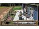 Outdoor patio with wicker furniture, grill, and outdoor dining; raised garden in the foreground at 1056 Riverstone Dr, Social Circle, GA 30025