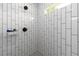 Modern shower features white subway tile with dark fixtures and showerhead at 1056 Riverstone Dr, Social Circle, GA 30025