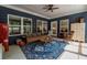 Sunroom with comfortable seating, accent rug, ceiling fan and plenty of natural light at 1056 Riverstone Dr, Social Circle, GA 30025