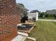 Brick home's backyard featuring a small patio and well-maintained lawn at 1266 Laurelwood Ct, Lawrenceville, GA 30045