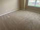 Bedroom features neutral carpet, neutral paint, and a large window at 1266 Laurelwood Ct, Lawrenceville, GA 30045