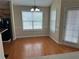Bright dining area with hardwood floors and plenty of natural light from the windows at 1266 Laurelwood Ct, Lawrenceville, GA 30045