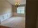 Formal dining area features a chandelier, large window, chair rail, and neutral carpet at 1266 Laurelwood Ct, Lawrenceville, GA 30045